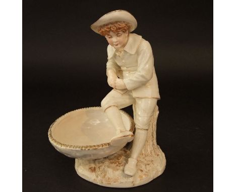 A Royal Worcester Hadley ivory glazed dish with basket weave moulding and applied figure of a boy, puce printed mark to base,