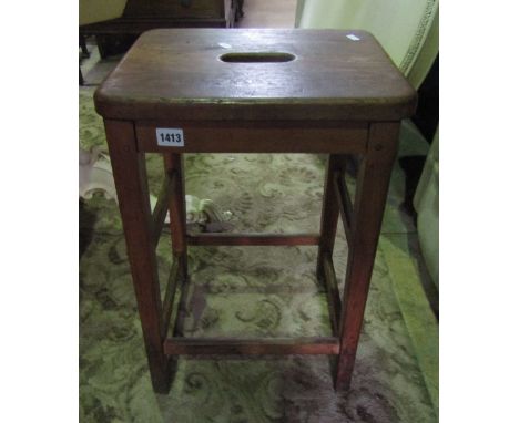 A vintage stained beech 'ER' wood stool with rectangular pierced elm seat 