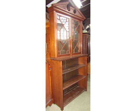 A Victorian walnut two tier bookcase, the lower section of open form with two shelves, the upper section enclosed by two astr