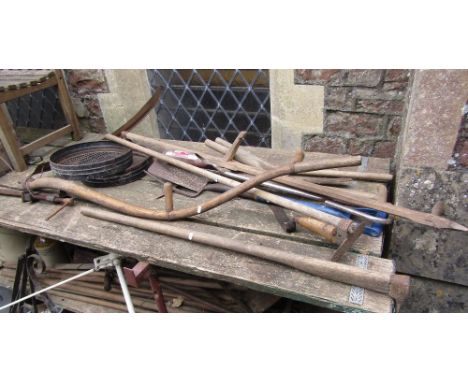A vintage agricultural scythe with long ashwood handle together with further vintage and more contemporary long handled tools