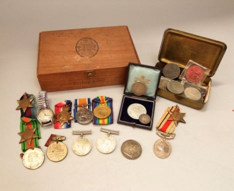 A box containing a collection of military related items to include a group of WWI medals issued to Private J Mills, Monmouth 