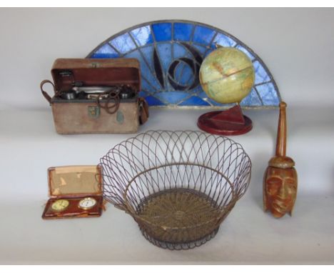 A mixed miscellaneous lot to include a Chad Valley tin globe, a leaded glass arch window, a tribal pipe, a travel clock, case