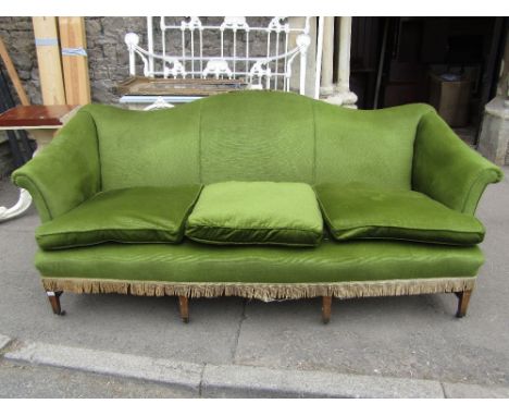 A Georgian style three seat camel back sofa with shaped outline, scrolled arms, green dralon upholstery and loose squab seat 