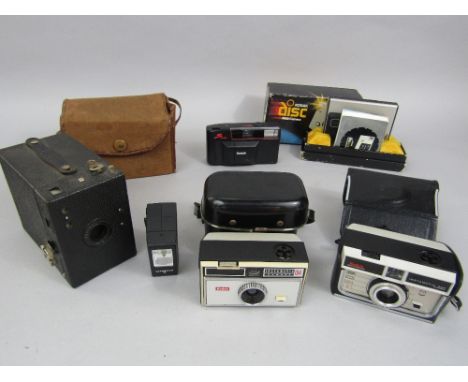 A box containing a collection of vintage Kodak cameras