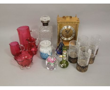 A mixed collection of glassware to include cranberry glass examples, glass paperweight, a decanter and further crackoline gla