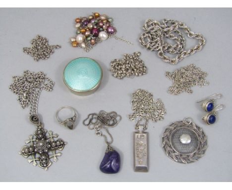 A collection of silver and white metal jewellery to include a circular pendant with laurel border in the style of Bernard Ins