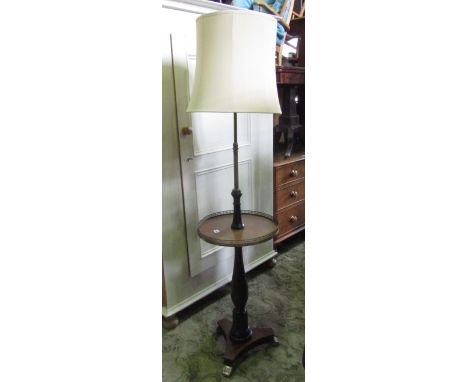 A lamp standard in a Georgian style with telescopic framework on scrolled toes