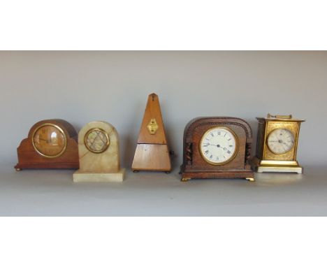 An interesting gilt brass gravity clock, the black dial with open escapement and Roman numerals, upon a stepped square base a