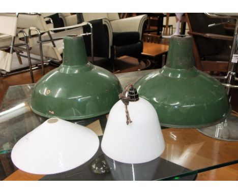 A pair of vintage green enamel pendant light shades of circular domed form 40cm in diameter approx together with two milk gla