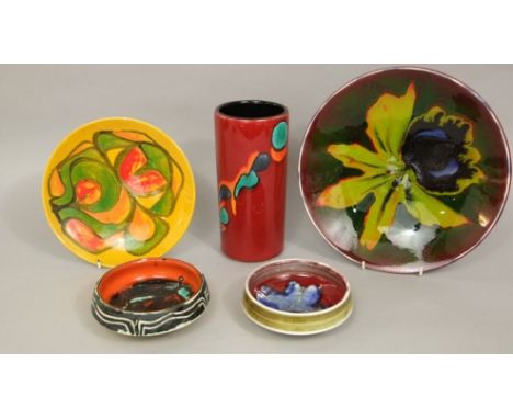A collection of five pieces of Poole pottery wares all with abstract detail including a Poole studio dish with iris detail, 2