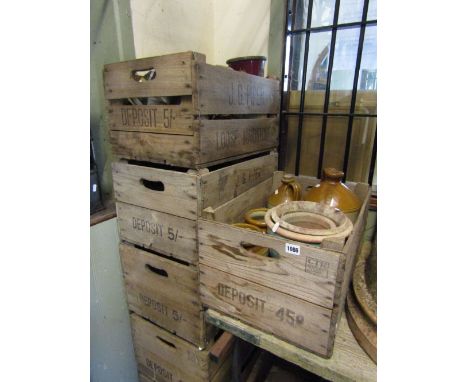 Six vintage wooden stacking crates with pierced handles and printed detail, two containing miscellaneous items to include sma