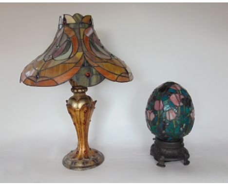 A Tiffany style table lamp with shaped leaded glass shade and gilt wood baluster column; together with a further Tiffany styl