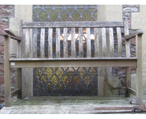 A Winchester Collection weathered teak garden bench with slatted seat and curved slatted back (4ft long), together with a fur