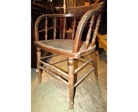 A pair of vintage stained beechwood office chairs with turned spindle bowed backs and supports united by stretchers