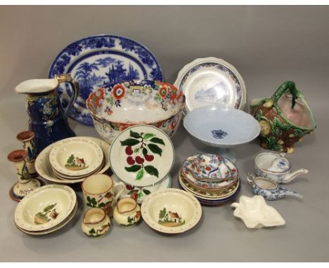 A collection of 19th century and other ceramics including a Majolica vase modeled as a tree trunk, an ironstone type punch bo