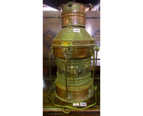 A vintage copper and brass framed ships lamp with sea horse trademark, serial number 53857