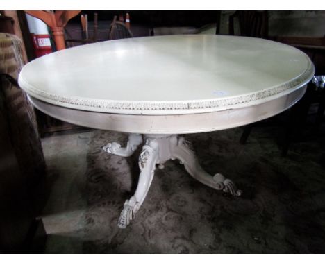 A Victorian mahogany tilt top breakfast table of oval form with moulded outline raised on a squat onion shaped pillar and scr