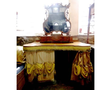 A good quality country house dressing table, the raised mirror back with carved C scroll and acanthus frame over a box base w