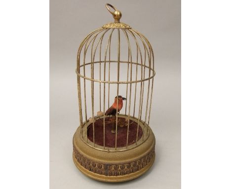 A vintage German signing bird in cage, with foliage, 26cm high (currently not working)