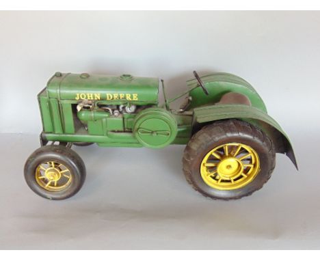 A scale model tin plate John Deere tractor with original cardboard box, 40cm long