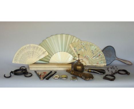 A box of interesting items to include a good embossed copper powder flask, together with a further powder flask, hand cuffs, 