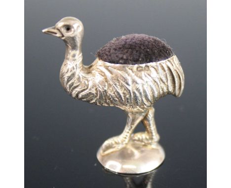 An Edwardian silver novelty pin cushion in the form of an emu, modelled in standing pose upon a rounded circular base, finely