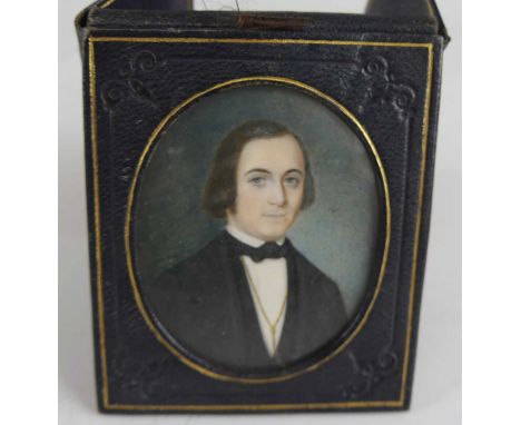Mid-19th century English school - Half-length portrait of a gentleman, wearing a bow tie and gold chain, miniature watercolou