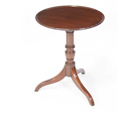 A Regency mahogany pedestal tripod table, having a circular dished tilt-top to a ring turned gun barrel urn column, the whole