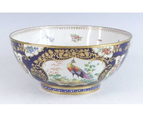 A Worcester style bowl, 19th century, decorated with cartouches of birds and flowers upon a blue scale ground, dia.29cmFine c