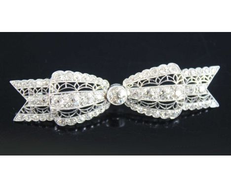 A white metal Art Deco bow brooch, featuring 61 Old European cut diamonds in grain and bezel settings, with filigree detail a