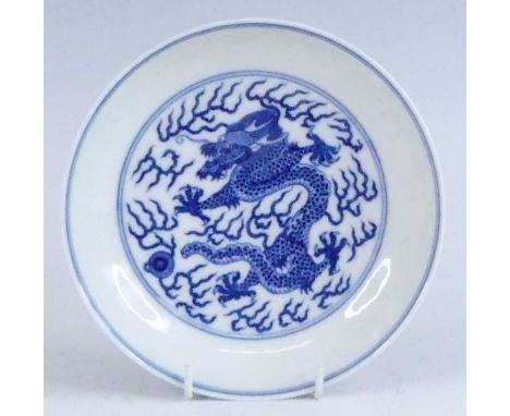 A Chinese blue and white porcelain dish, Daoguang period, decorated with a five clawed dragon chasing a pearl, underglaze zha