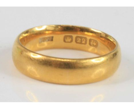 A 22ct 5.4mm court shaped wedding band, size O½, gross weight 8g, hallmarked 22ct, Birmingham, no date, sponsor R&amp;S