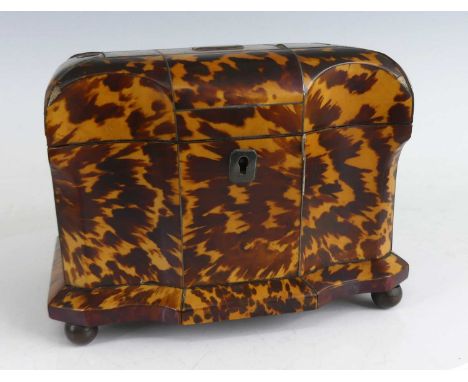 A circa 1830 tortoiseshell and white metal inlaid tea caddy, of shaped rectangular form, the hinged cover opening to reveal t