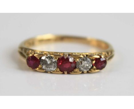 An early 20th century 18ct yellow gold, ruby and diamond half hoop ring, comprising three graduated round rubies and two old 