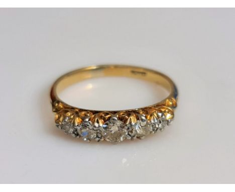 A late 19th/ early 20th Century five stone diamond ring, set with three Old European cut diamonds flanked by two single-cut d