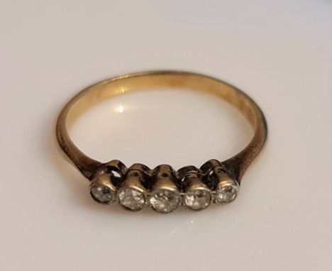 A five stone diamond ring, bezel set with a central Old European cut diamond flanked by four single-cut diamonds, total diamo