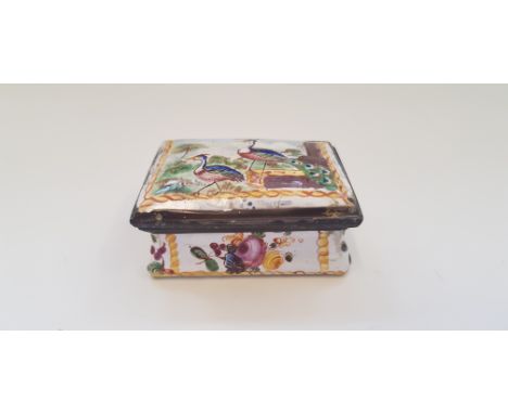 A hand painted enamel pill box with peacock design to top and floral design to sides. IMPORTANT: Online viewing and bidding o