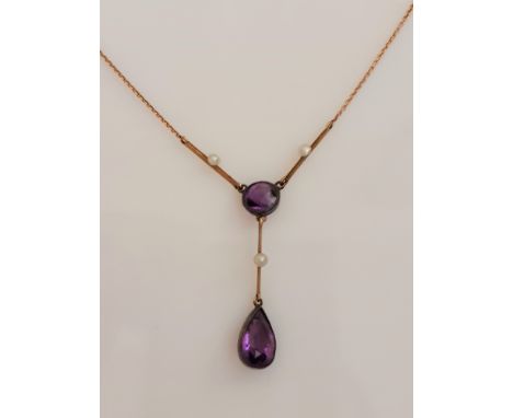 An amethyst and seed pearl drop necklet, set with a pear cut amethyst suspended from a round cut amethyst and knife edge link