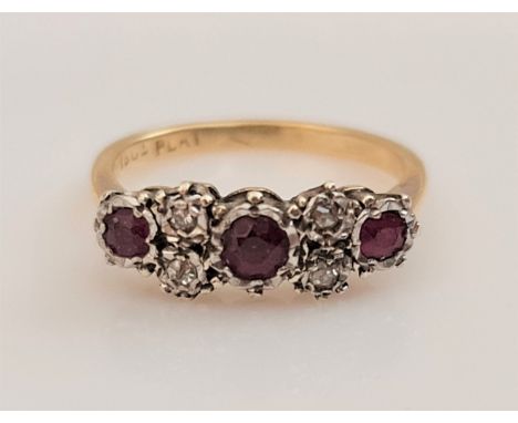 A ruby and diamond ring, set with three round cut rubies separated by four single-cut diamonds, stamped 18ct PLAT, ring size 