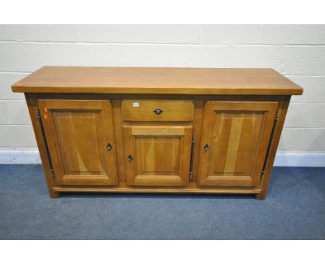A SOLID OAK SIDEBOARD, with a single central drawer, and three fielded panel cupboard doors, width 172cm x depth 50cm x heigh
