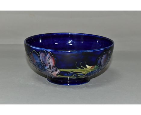 A MOORCROFT POTTERY 'ANEMONE' BOWL, tube lined with red and purple anemones on a dark blue ground, painted and impressed mark