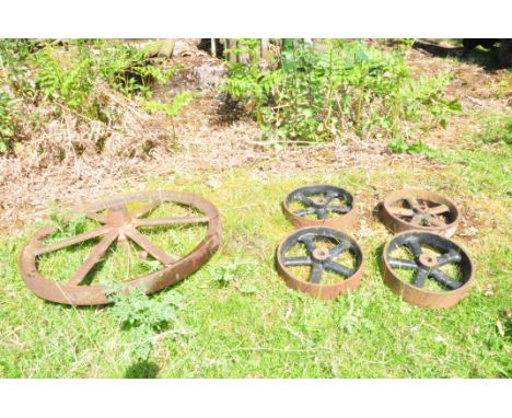 FIVE VINTAGE CAST IRON WHEELS one at 62cm diameter the other four at 24cm (these items are offsite and separate arrangements 