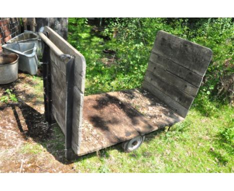 A VINTAGE RAILWAY PORTERS TROLLEY with cast iron frame, wooden bed and sides width 152cm depth 76cm height 104cm Condition wo