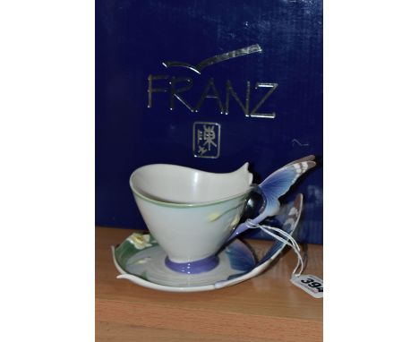 A BOXED FRANZ PORCELAIN TEACUP AND SAUCER, in the Blue Butterfly pattern FZ00056 (2 + box) (Condition Report: pieces appear i