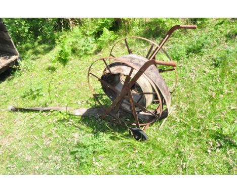A VINTAGE FIRE HOSE REEL with distressed hose attached height 84cm Condition some pitted surface rust(these items are offsite