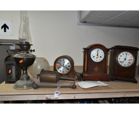 A GROUP OF CLOCKS AND LANTERNS, comprising a leather bound lead cosh, both ends bear a horse's head logo, length 30cm, a tin 