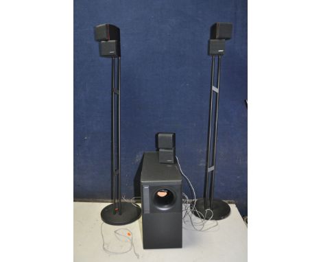 A BOSE ACOUSTIMASS 7 HOME CINEMA SPEAKER SYSTEM, with three satellite speakers, two stands and a sub-woofer (tested and all a