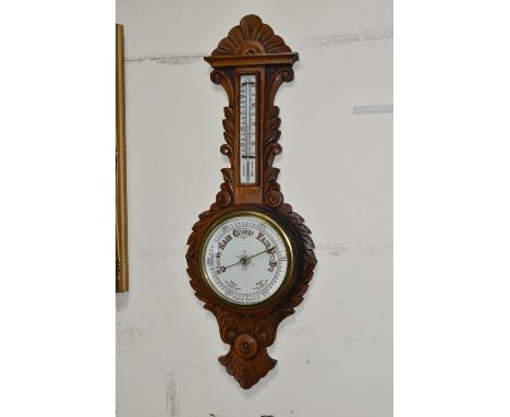A VICTORIAN OAK CASED ANEROID BAROMETER, heavily carved with a mercury thermometer, height 86cm x width 32cm, together with a