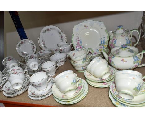 TWO PARAGON TEA SETS, comprising a twenty four piece tea set printed and tinted with butterflies, hollyhocks and other flower