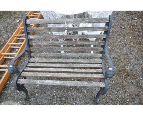 A WOODEN SLATTED GARDEN BENCH, with wrought iron ends, depicting lion masks, length 100cm (condition - rickety, paint peeling